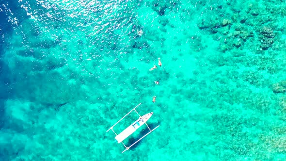 Aerial drone shot scenery of perfect coastline beach time by blue water and bright sandy background 