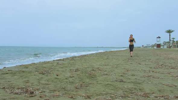 Female Athlete Training at Seaside, Running on Sandy Beach. Success Motivation