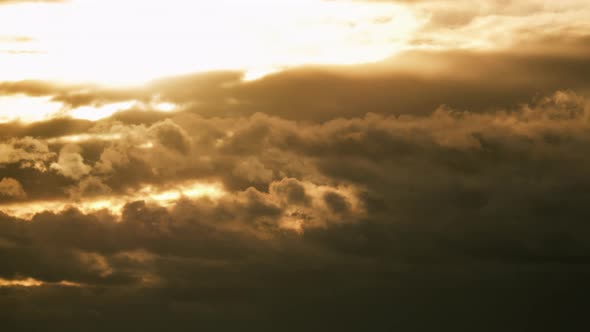 Dramatic Sunset in the Sky Through Orange Layered Cumulus Clouds Timelapse