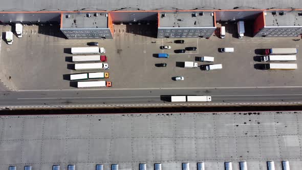 The white truck drives through the territory of the logistics center
