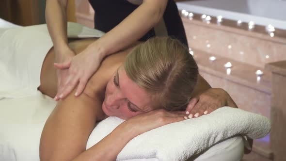 Professional Girl Doing a Woman Relaxing Back Massage