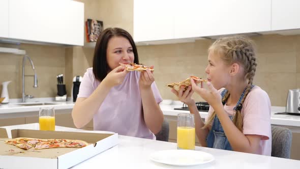 Happy Smiling Family of Two Eagerly Eat Delicious Pizza Little Girl Daughter with Sits with Her