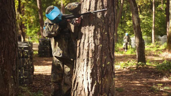 Playing Paintball Battle Friends Wearing Camouflage Protective Masks Engage in Leisure Activity