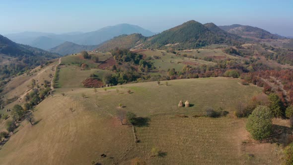 Autumn mountain with peaks, meadows and colorful forests