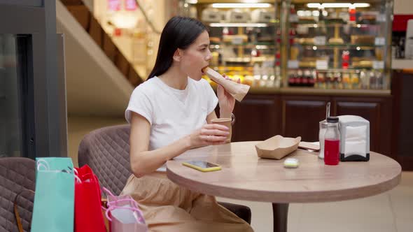 Woman Drinking Coffee and Having Lunch in Cafe at Shopping Mall