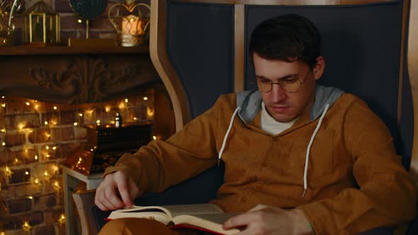 Young Man in Glasses Reading Book