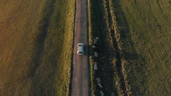 Aerial View of a Car Driving on Country Road