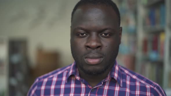 African American Male Looking in Camera Very Seriously