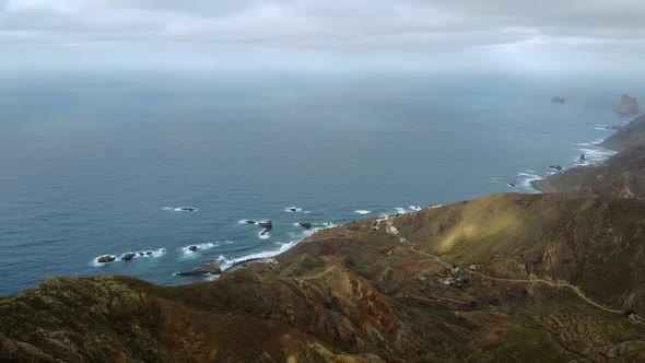 Open Clear Blue skyAerial Overview Above the Mountainous Coastline Small Houses Stretching Along the