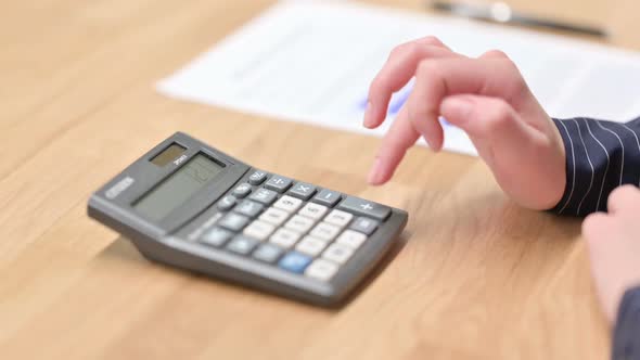 Close Up of Hand Using Calculator