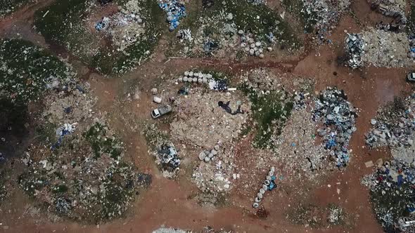 Aerial view of a landfill with piles of trash scattered all over the site - bird's eye view