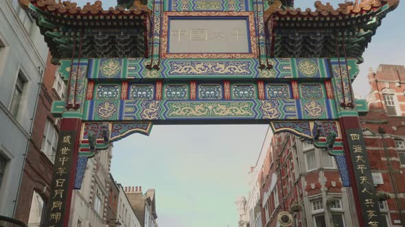 Upwards looking, smooth walking shot of the big entrance gate in Chinatown London.