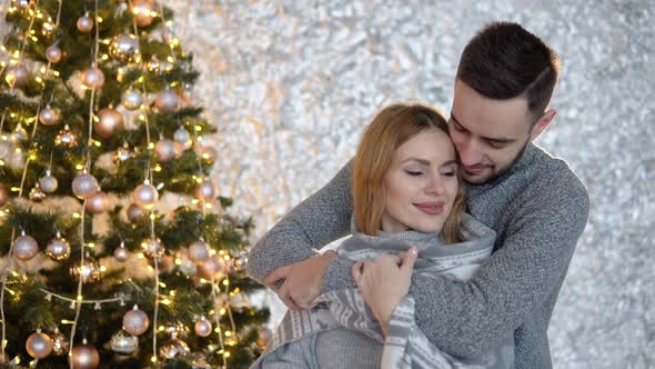 Couple Decorating the Christmas Tree Together in the Christmas Eve