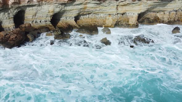 Ocean Waves Crash Against the Rocky Shore the Coastline of the Mediterranean Sea During a Storm