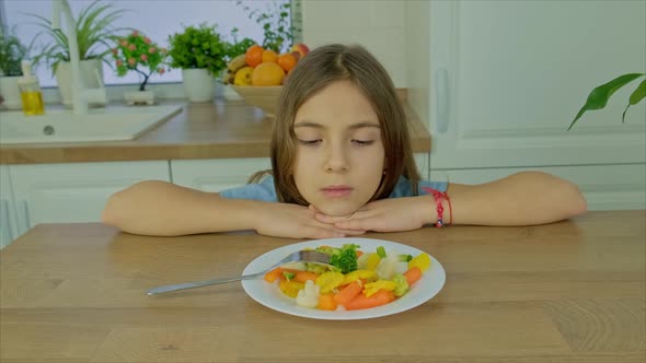 The Child Eats Boiled Vegetables