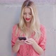 Glad Female Using Cellphone Near Wall - VideoHive Item for Sale