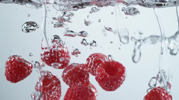 Slow motion shot of raspberries splashing into water, shot with Phantom Flex 4K camera.
