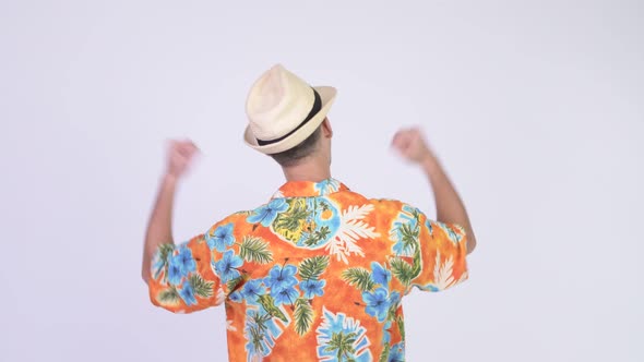 Rear View of Tourist Man with Fists Raised Ready for Vacation