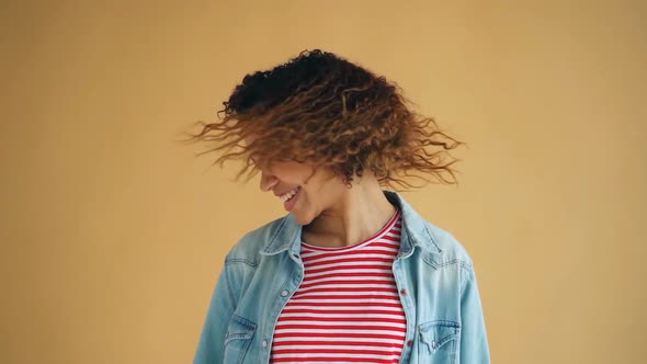 Slow Motion of Attractive Mixed Race Girl Shaking Head Waving Curly Hair