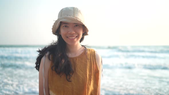 young Asian woman having relaxed and freedom time, walking enjoy on the tropical sea beach