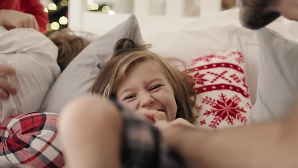 Video of parents tickle children in bed on Christmas morning.  Shot with RED helium camera in 8K