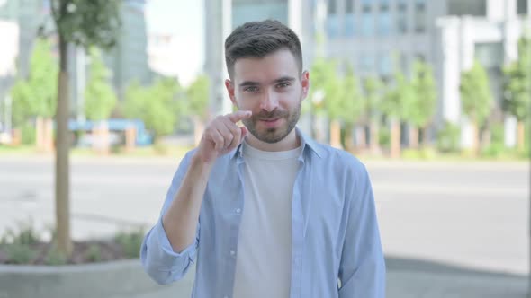 Stressed Young Man Showing Stop Gesture Outdoor