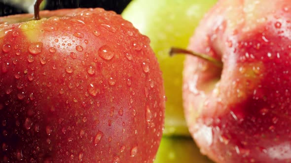 Closeup Slow Motion Video of Water Droplets Falling on Fresh Ripe Red and Green Apples