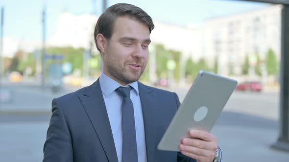 Video Call on Tablet by Businessman Outdoor