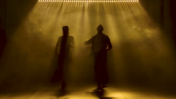 Concept of Social Dance and Relationships. Silhouette of Young Beautiful Couple Dancing Sensual