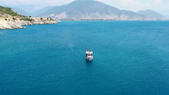 Aerial drone circling a turkish sailboat in the coastal waters of the Mediterranean Sea near Finike