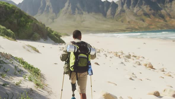 Sporty mixed race man with prosthetic leg hiking