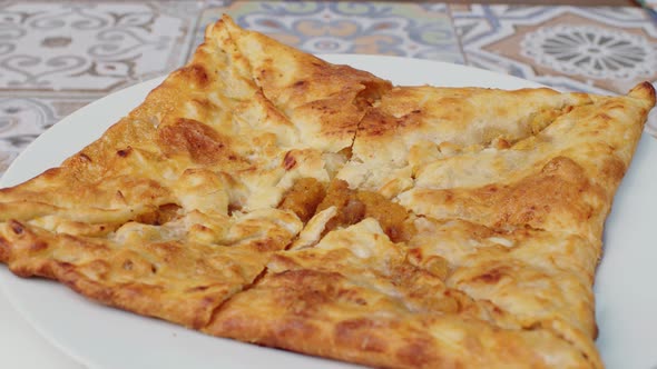 Close Up of Georgian Pie Spinning Round on Plate