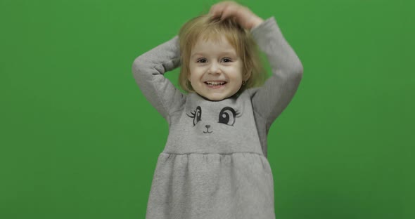 Kid Girl on a Green Screen, Chroma Key. Happy Three Years Old Girl