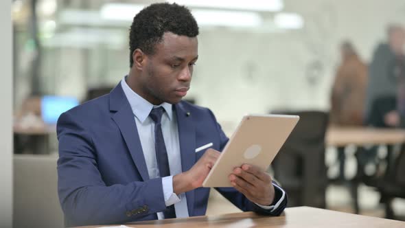 African Businessman Using Tablet at Work