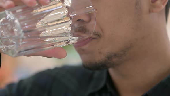 Close Up of African American Man Drinking Water