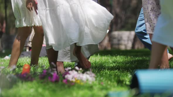 Women in Traditional Clothing Dancing on the Grass with Bare Feet During Folk Festival