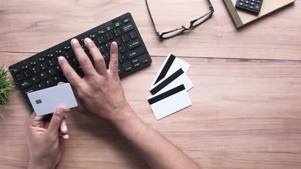 Man Hands Holding Credit Card and Using Keyboard Shopping Online 