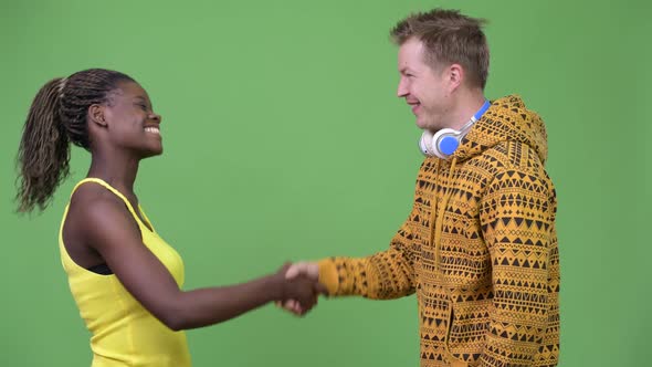 Young Multi-ethnic Couple Shaking Hands Together