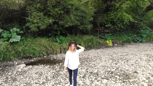 Aerial Drone View of Young Woman Walk Along Mountains River in Summer Morning