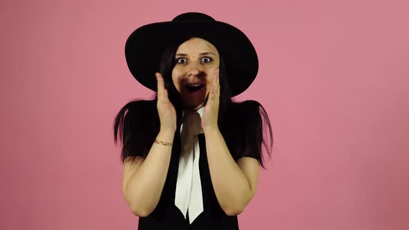 Lady Smiling on a Pink Background. Woman Pleasantly Surprised