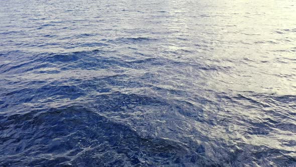 Aerial View of a Crystal clear sea water texture. Waves in motion