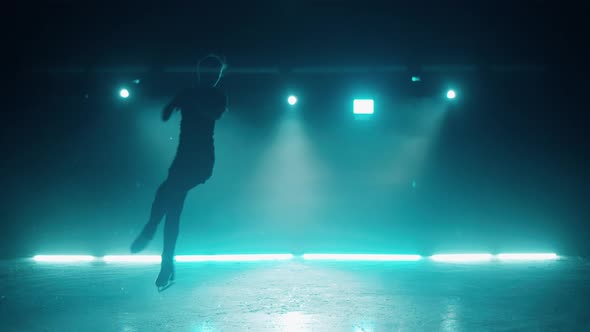 Figure Skater is Practicing Jumps on the Rink