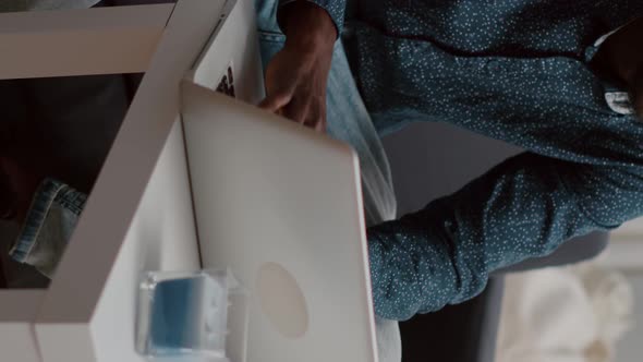 Vertical Video Authentic Smiling Black African American Guy Working From Home at His Laptop