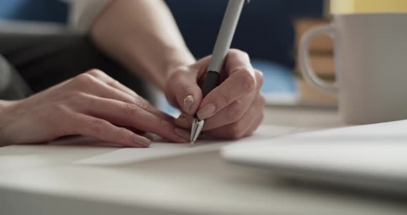 Cropped Student Taking Notes in Notebook at Home