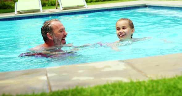 Family enjoying in swimming pool