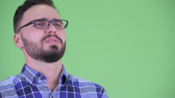 Face of Stressed Young Bearded Hipster Man Getting Bad News