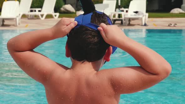 Boy Putting on Mask