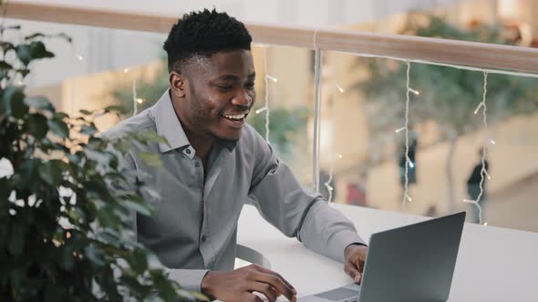 Young Joyful Man Communicating Via Video Call on Laptop Talking Supports Motivates to Friend Remote