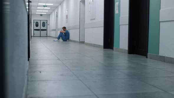 Tired Doctor Sitting Hospital Corridor Floor