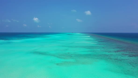 Daytime aerial abstract shot of a paradise sunny white sand beach and aqua blue water background in 